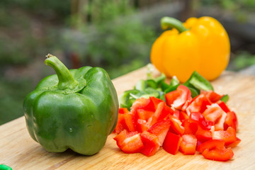 sweet peppers on wooden background