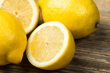 Several fresh and juicy lemons on wooden table