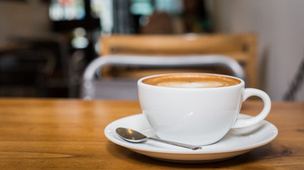 Hot art Latte Coffee in a cup on wooden table.