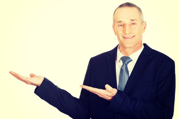 Businessman with welcome gesture