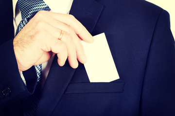 Businessman taking a blank card from pocket