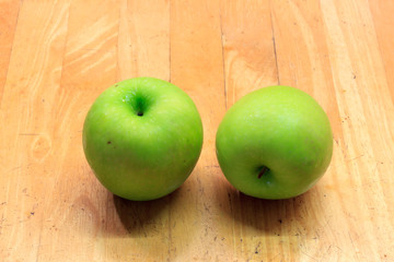 apples on wood background.