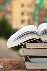stack of books on city background