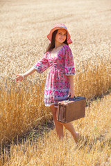 girl in hat on wheat field