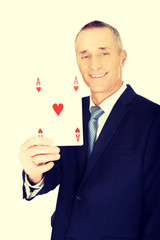 Elegant businessman with red ace card