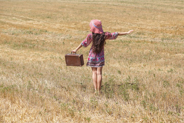 girl in hat on wheat field