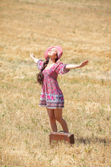 girl in hat on wheat field