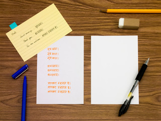 Hindi; Learning New Language Writing Words on the Notebook