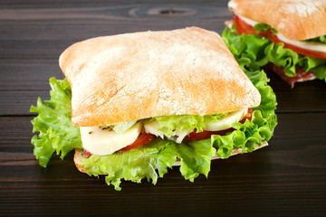 Sandwich with mozzarella, tomato and lettuce