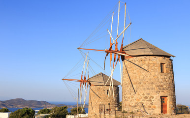 Windmills in the setting sun on the island of Patmos. Dodecanese archipelago in the Aegean Sea in Greece