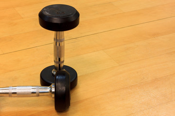 Dumbbells on the wood background.