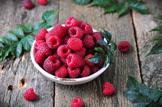 organic raspberries on a wooden background