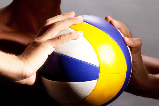 the athlete holds a volleyball