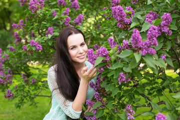 Girl smelling the lilac flowers