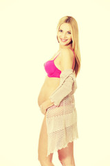 Pregnant woman in lingerie and cardigan