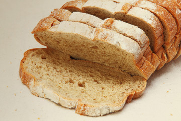 Fresh sliced bread on white fabric taken closeup.