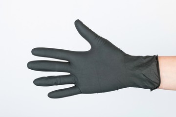 Hand in black medical glove. Stock image macro.