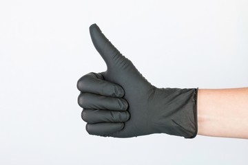 Hand in black medical glove. Stock image macro.