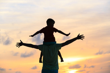 father and son on sunset beach