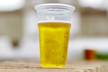 Glass of plastic with draft beer