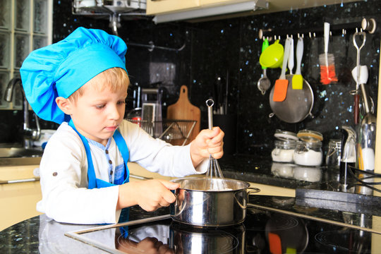 Little Boy Enjoy Cooking In Kitchen