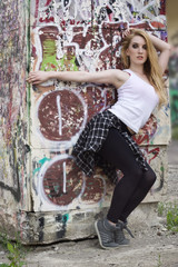 Young woman dancer on graffiti background