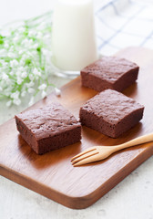 Chocolate brownies on wood plate