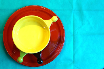 Three small bowl standing on big red dish