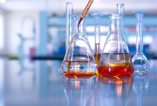science laboratory glassware orange solution