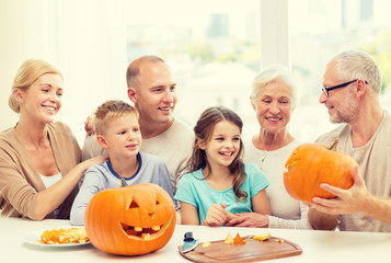 happy family sitting with pumpkins at home