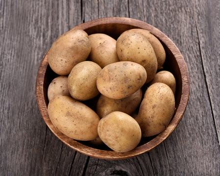 Raw potatoes in bowl