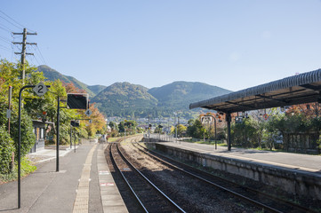 Railway track with Yufuin city and autumn mountain background , oita, Japan