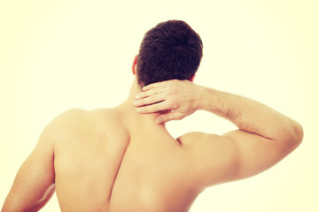 Obraz premium Athletic man feeling pain in his neck.