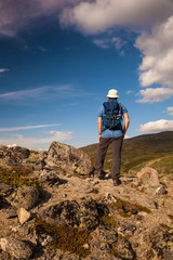 Fototapeta premium hiker with backpack travelling in Norway mountains Dovre