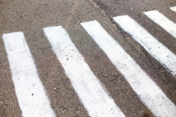 incorrect road markings. too narrow strip of road marking on a pedestrian crossing zebra