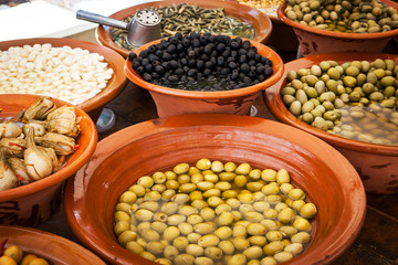 Different marinated olives and local food on spanish street mark