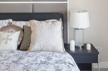 luxury bedroom with glass lamp on dark brown wooden table