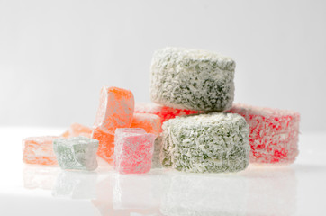 Sweets Turkish Delight, fruit jelly in coconut chips color on a