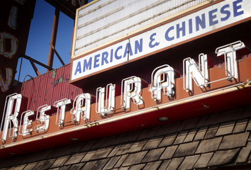 Obraz premium aged and worn vintage photo of old neon restaurant sign