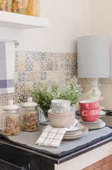 set of plates and dish on counter in kitchen room