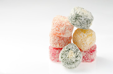 Sweets Turkish Delight, fruit jelly in coconut chips color on a