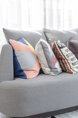 colorful pillows on modern grey sofa