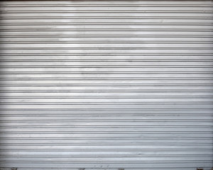 Gray roller shutter metal garage gate, texture