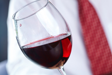man handing glass of wine