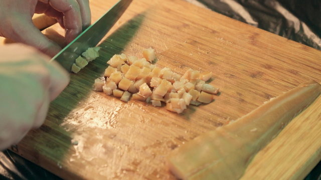 Cook cutting fillets of smoked fish into cubes