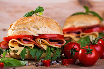 Italian ciabatta with ham and cheese on the wooden background