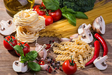 Pasta ingredients on a wood background