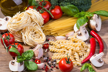 Pasta ingredients on a wood background
