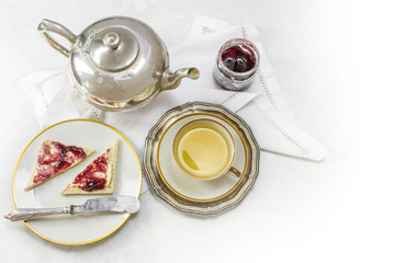 breakfast with tea, sandwich and jam on white marble as a corner