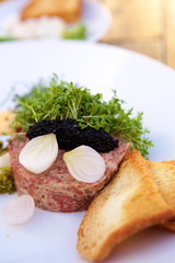 Plate with steak tartare and caviar